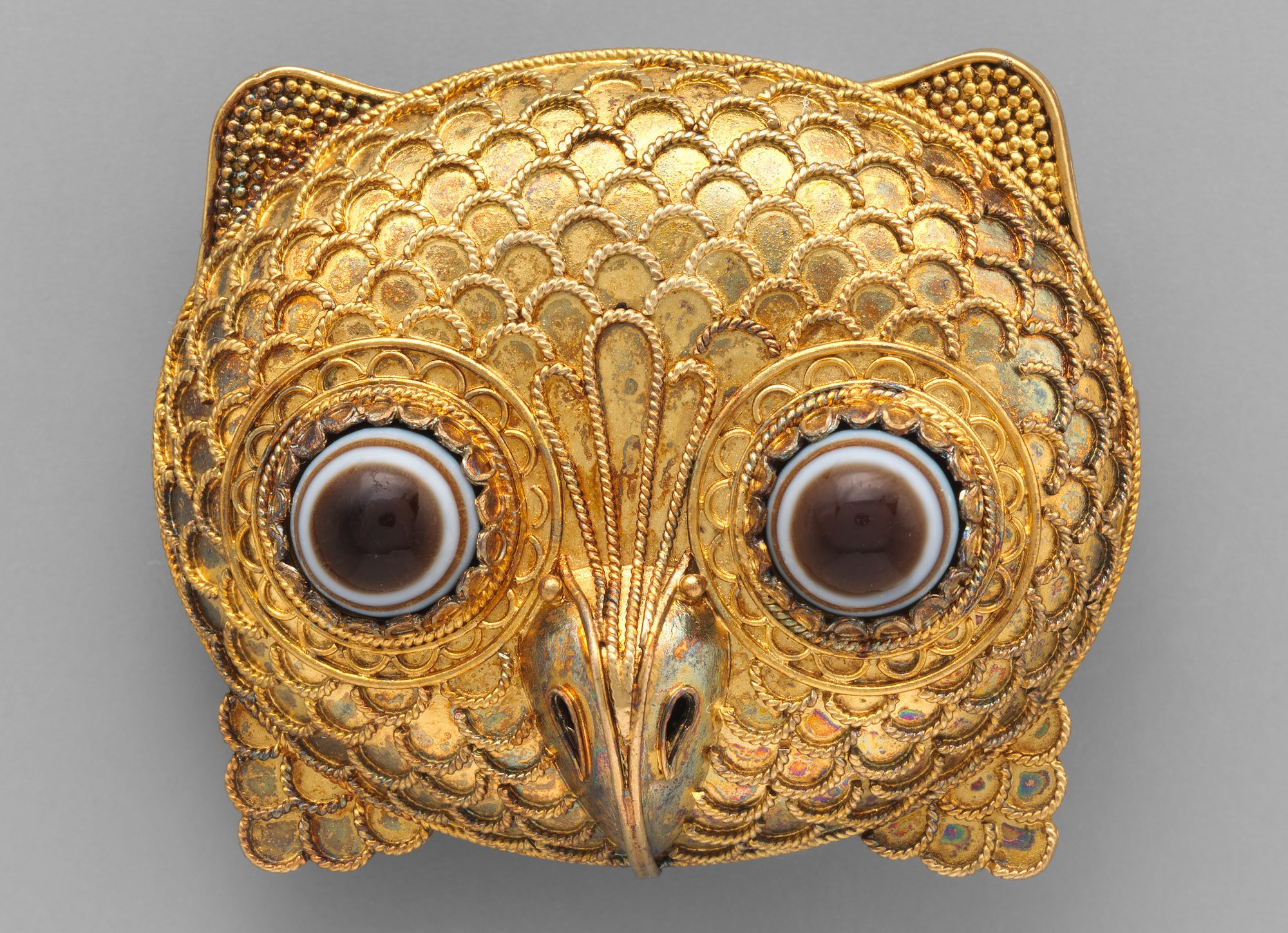 Etruscan revival gold brooch in the form of an owl head with agate eyes, ca. 1860