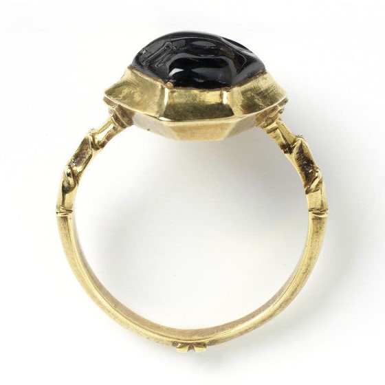 gold ring, the hexagonal bezel set with a sapphire, the shoulders decorated with chased dragon-heads, possibly France, ca. 1300