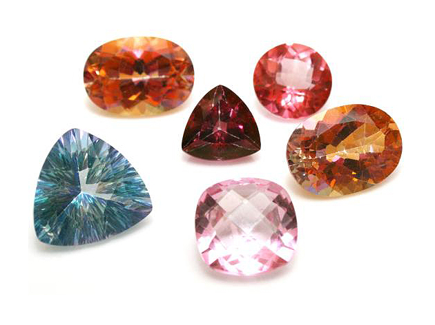 six topaz gemstones in various colors, blue, red, pink and orange